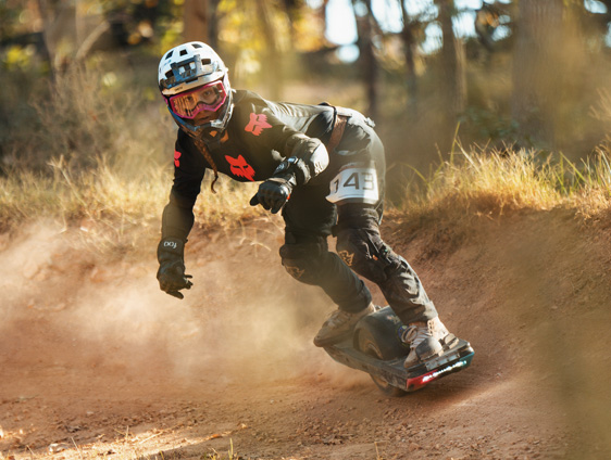 Onewheel rider railing a turn on the race circuit